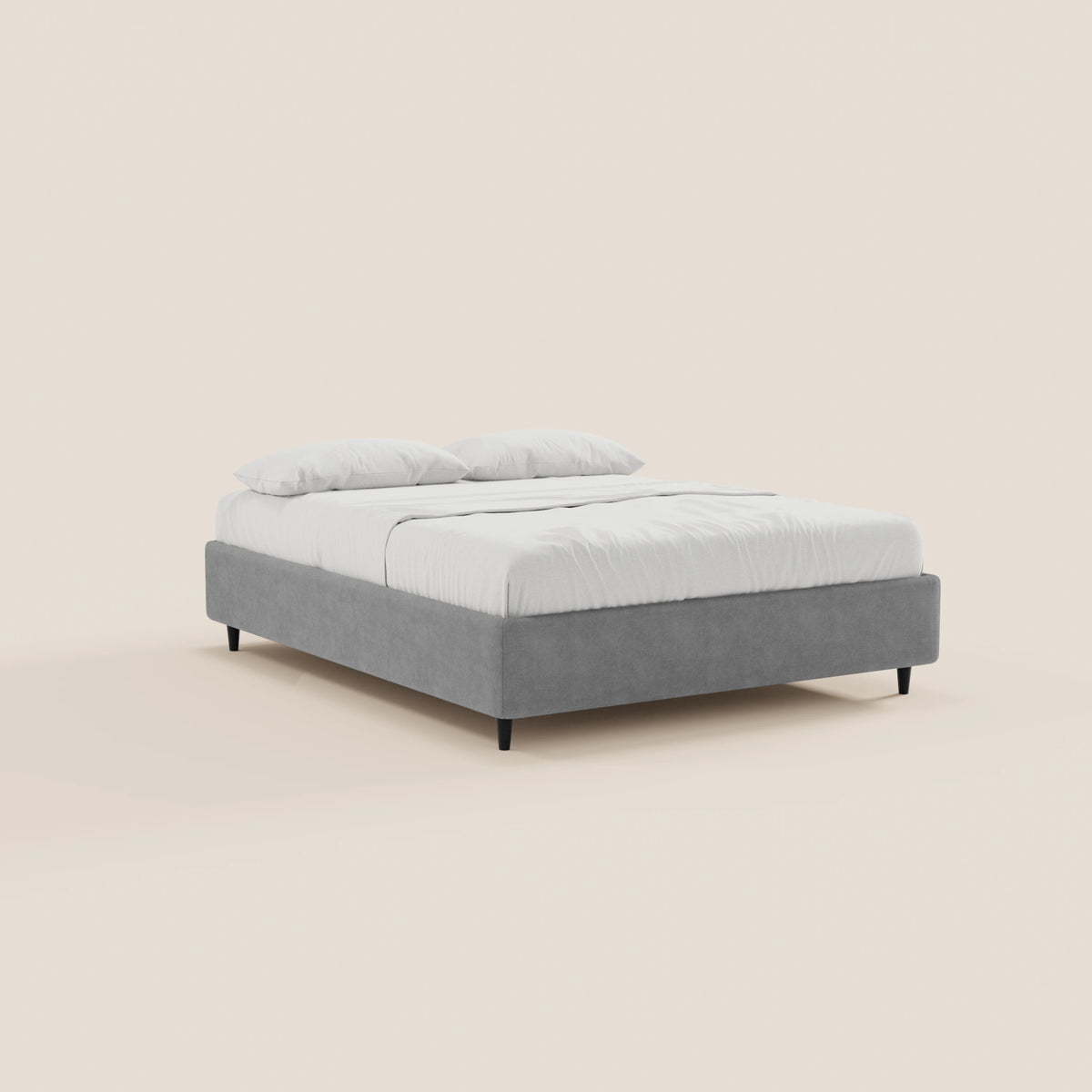 Il letto sommier imbottito ERON di Letti.store è un moderno contenitore realizzato in tessuto impermeabile certificato Oeko-Tex, dal profilo ribassato, rivestito in grigio chiaro con gambe nere sottili, biancheria da letto e cuscini bianchi su uno sfondo beige essenziale.
