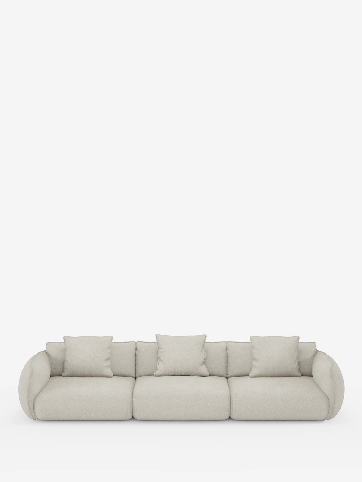 Un moderno divano modulare a 3 posti Nimbus di divitt.sbs, rivestito in morbido tessuto T33 effetto cotone, resistente alle macchie, in beige chiaro. Questo divano presenta tre ampi cuscini di seduta, cinque cuscini coordinati, braccioli arrotondati e uno schienale basso, il tutto messo in risalto da uno sfondo bianco a tinta unita che esalta il suo design minimalista e versatile.