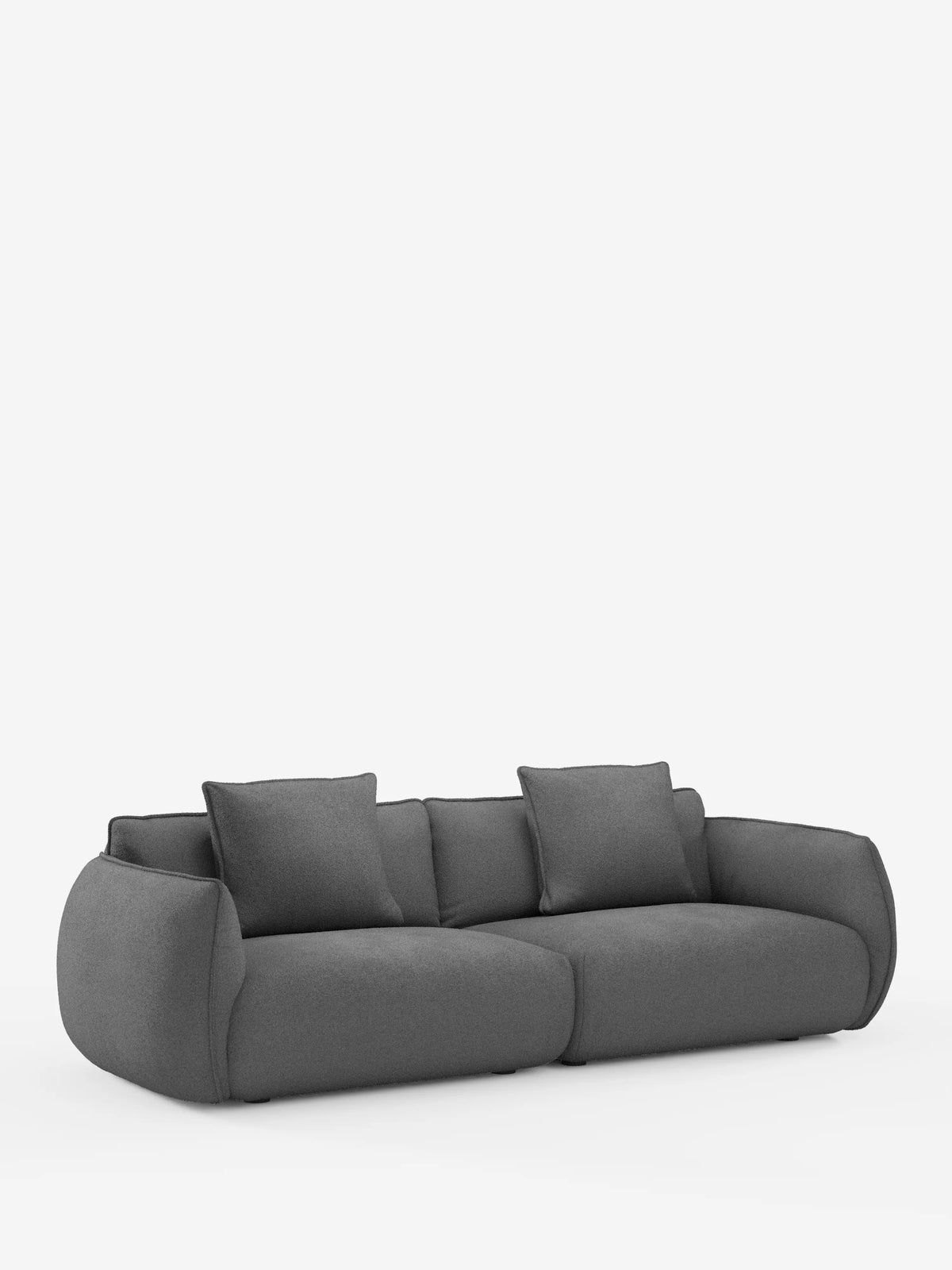 Vi presentiamo il divano modulare e componibile a 3 posti Nimbus di divitt.sbs, un divano moderno di colore grigio scuro che misura 250 cm. Rivestito in tessuto effetto cotone (t33) resistente alle macchie e sfoderabile, questo modello presenta bordi morbidi e arrotondati e quattro grandi cuscini coordinati. Su uno sfondo bianco a tinta unita, la sua silhouette minimalista si distingue per il profilo basso e l’aspetto morbido e accogliente, perfetto per gli spazi abitativi contemporanei.