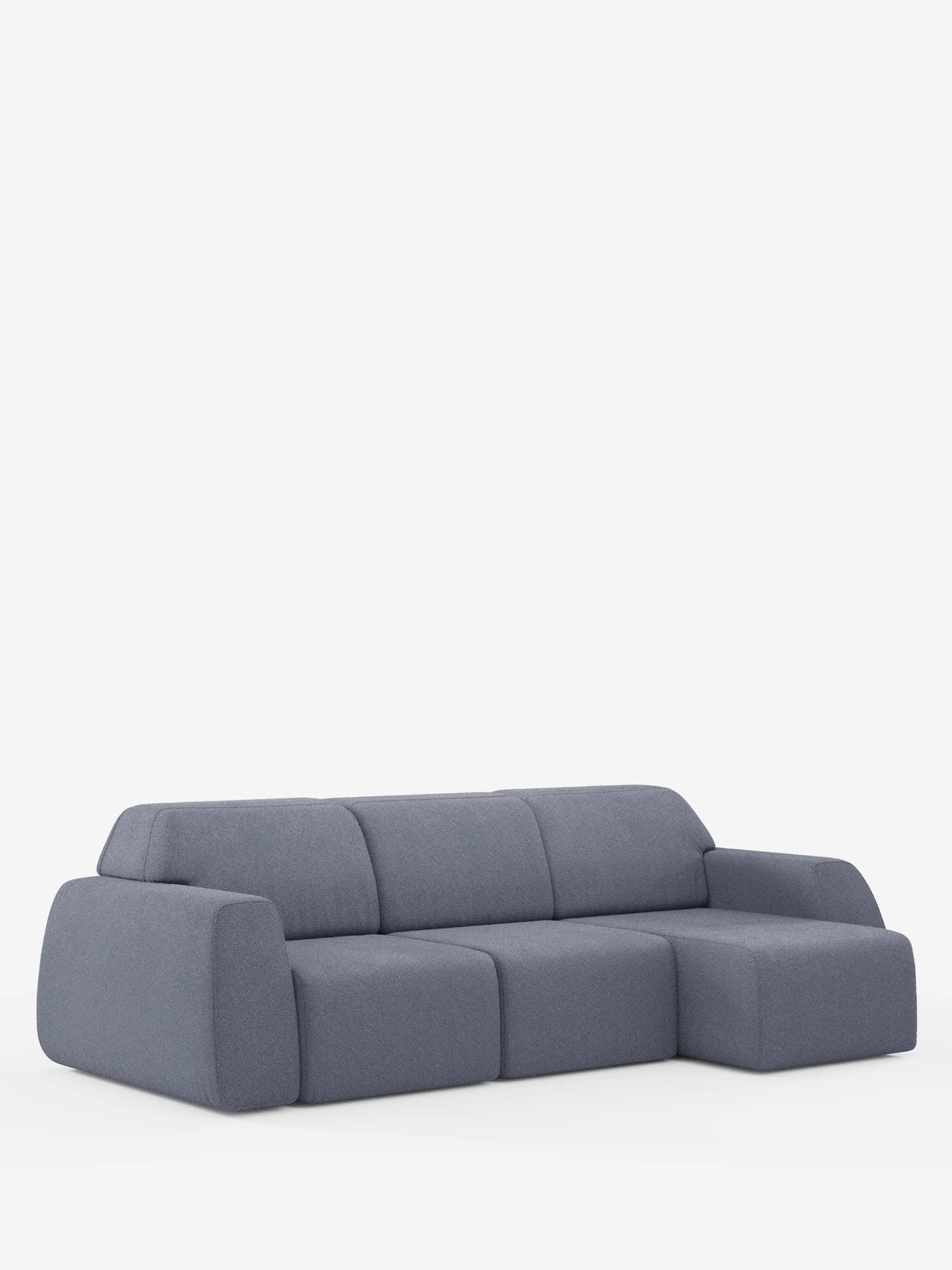 Un divano componibile moderno e minimalista in tessuto grigio, con bordi arrotondati e una chaise longue sul lato destro, su uno sfondo bianco a tinta unita. Il divano angolare Orbit con penisola reversibile e tutte le sedute allungabili in tessuto smacchiabile effetto cotone T33 di divitt.sbs presenta sedute e schienali imbottiti e spessi, per un look accogliente e contemporaneo.