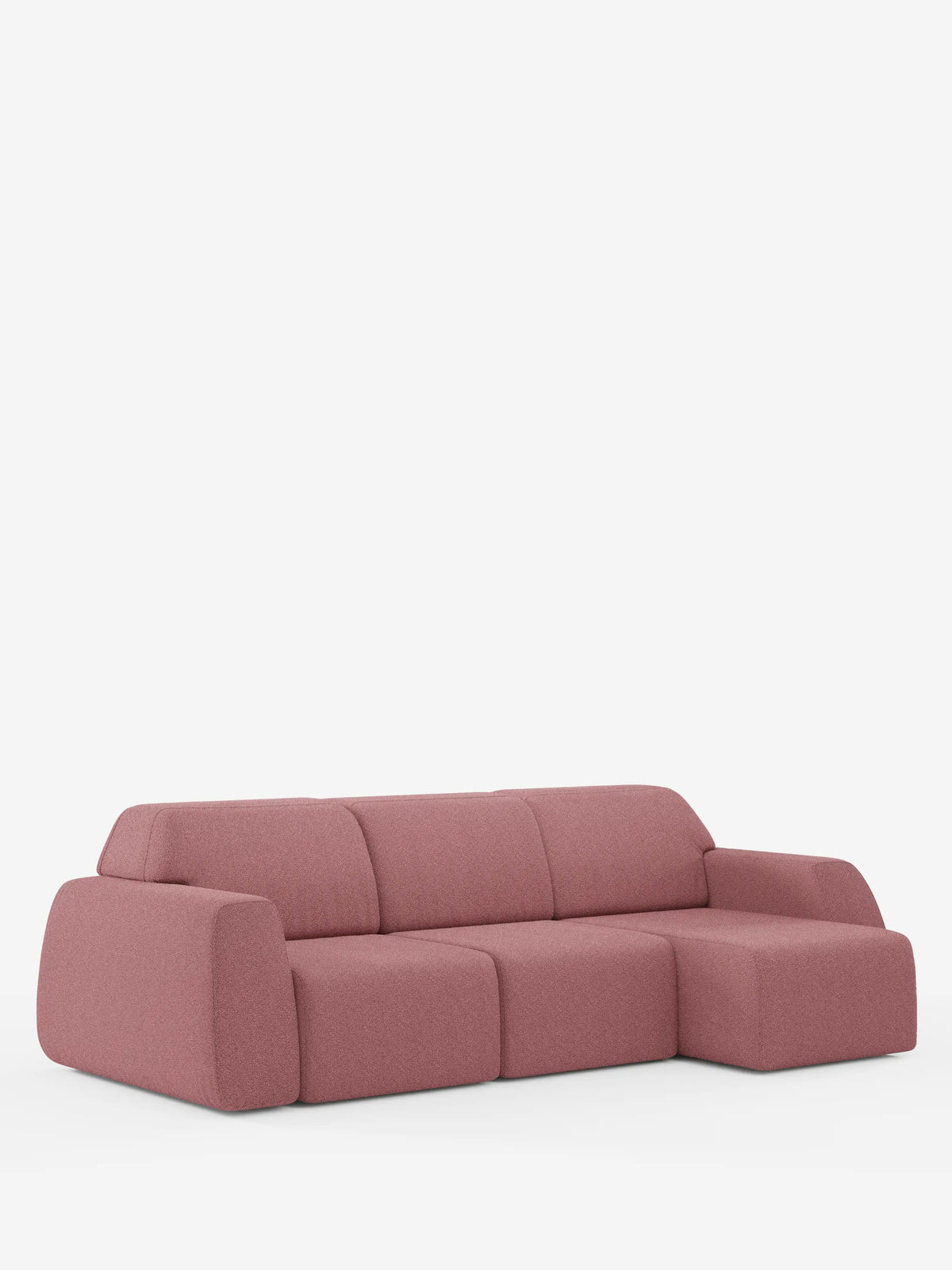 Un divano angolare Orbit contemporaneo di divitt.sbs, rivestito in tessuto T33 effetto cotone color rosa polveroso e resistente alle macchie, caratterizzato da bordi arrotondati, ampi braccioli e una sezione chaise longue reversibile sul lato destro, presentato su uno sfondo bianco a tinta unita. Tutte le sedute sono allungabili per un maggiore comfort.