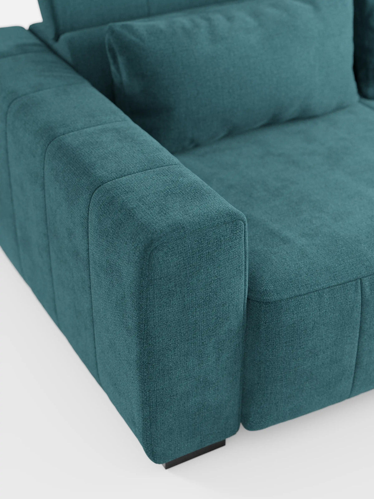 Primo piano del divano dorico a 3 posti di divitt.sbs in colore verde acqua, con particolare attenzione al bracciolo sinistro e al cuscino di seduta. Questo divano presenta una silhouette moderna e squadrata, con rivestimento in tessuto T23 liscio, testurizzato e smacchiabile, e sedute spesse e morbide. Il design comprende sedute allungabili con funzione relax elettrica e poggiatesta reclinabile. Lo sfondo è bianco a tinta unita.