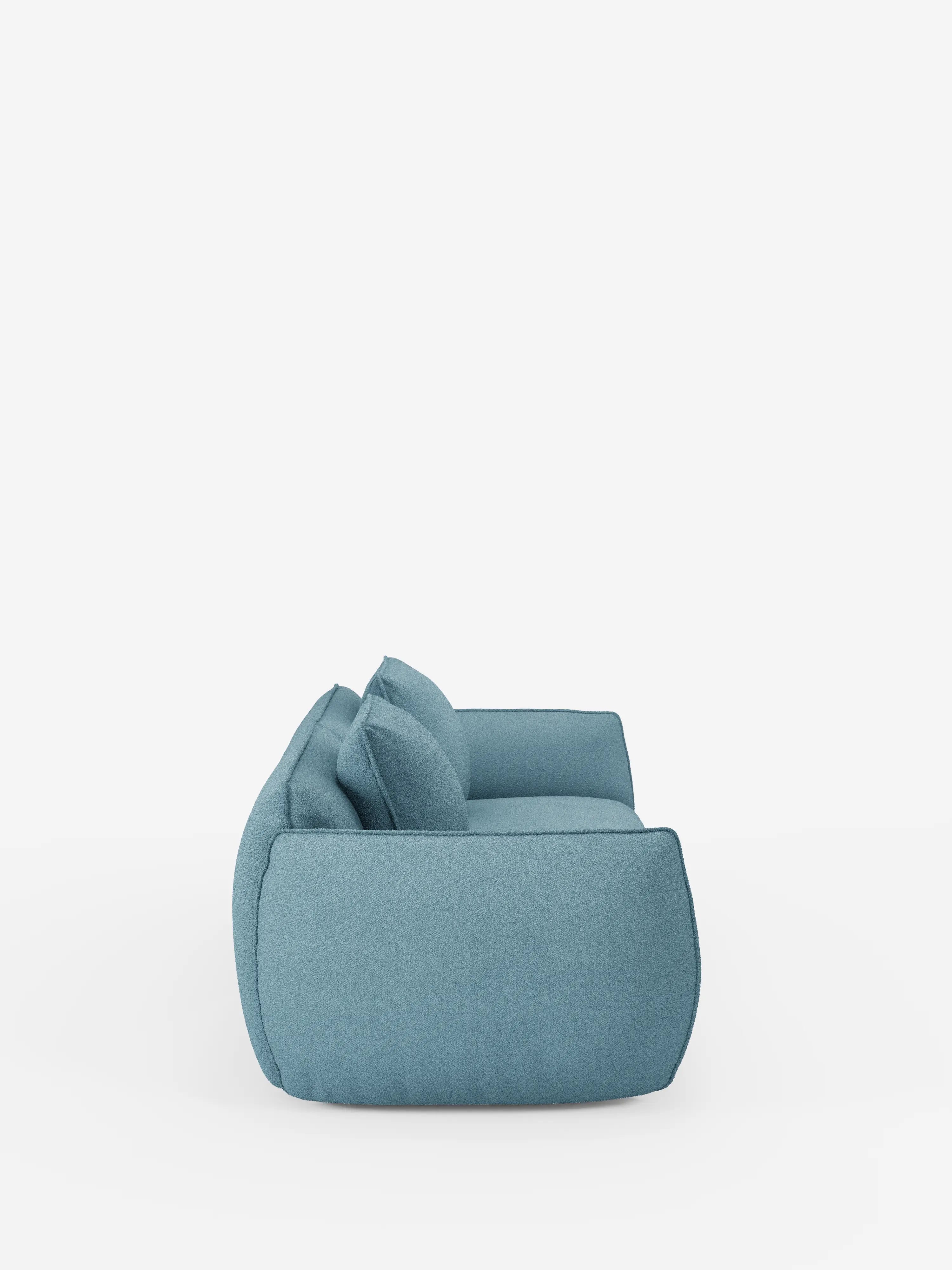 Il divano Nimbus a 3 posti, modulare e componibile, da 250 cm, realizzato in tessuto blu contemporaneo da divitt.sbs, è raffigurato di profilo, mettendo in risalto la sua silhouette squadrata, i bordi morbidi e i due cuscini dello schienale su uno sfondo bianco. Questo divano modulare e riconfigurabile offre un comfort avvolgente grazie al rivestimento T33 rimovibile, effetto cotone e resistente alle macchie, proponendo uno stile minimalista e soluzioni versatili per adattarsi a qualsiasi ambiente.