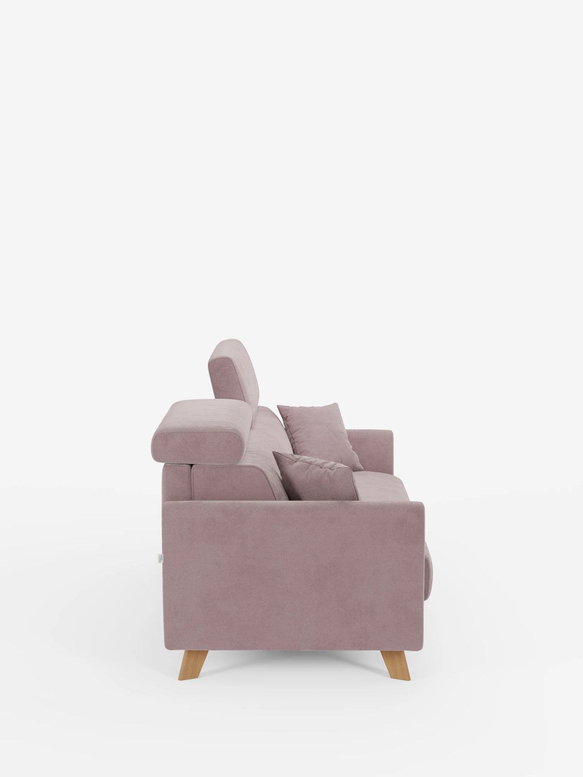 Una vista laterale del divano letto Francy con poggiatesta regolabili di divitt.sbs, qui raffigurato in un moderno tessuto color malva. Questo elegante divano a tre posti è dotato di poggiatesta regolabili, due cuscini coordinati, gambe in legno chiaro ed è completamente sfoderabile grazie al rivestimento T30 antimacchia. Lo sfondo bianco a tinta unita mette in risalto il design raffinato e i dettagli del divano.