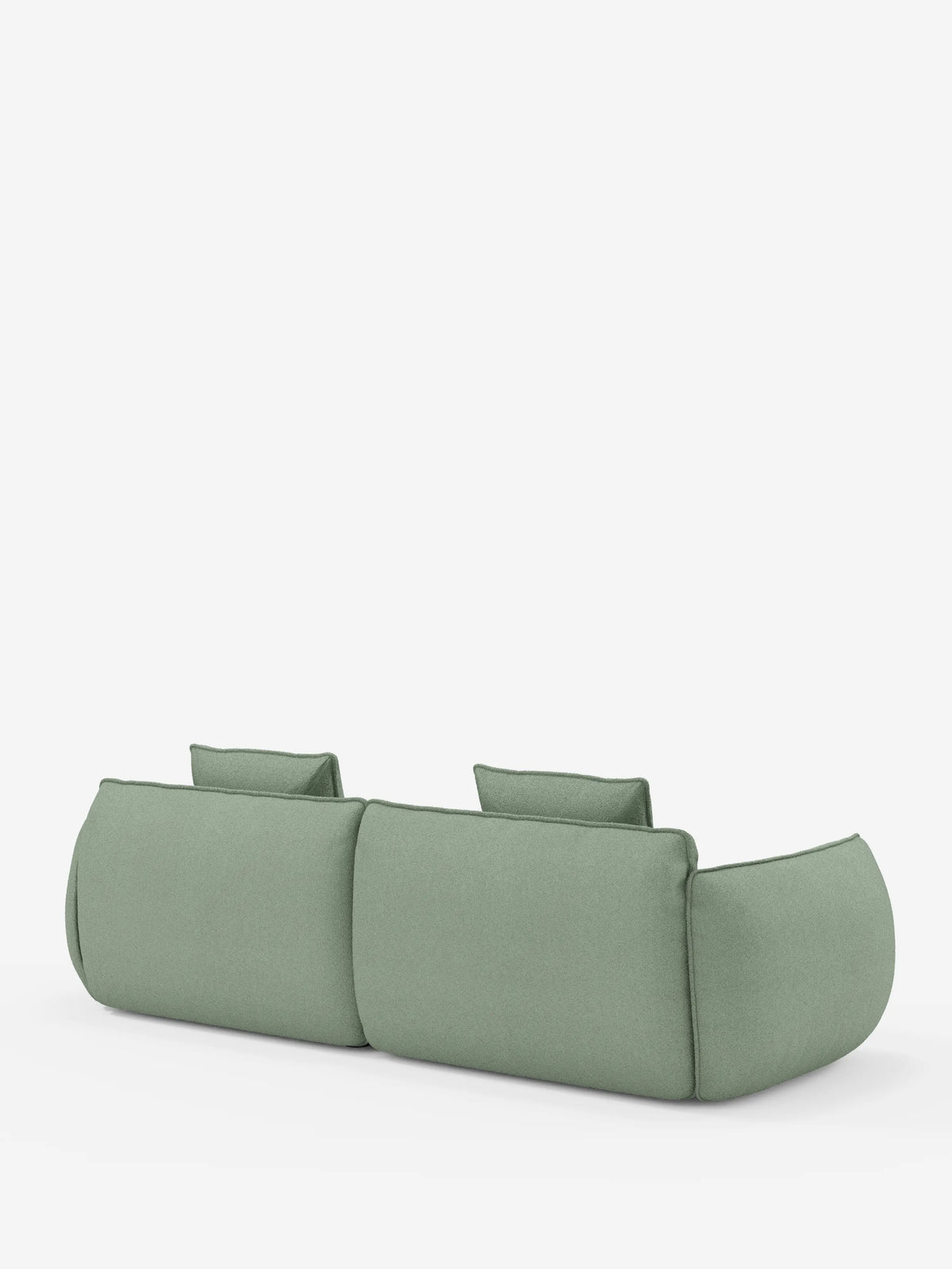 Il divano Nimbus, un modello moderno e minimalista a 3 posti, modulare e componibile da 250 cm di divitt.sbs, è rivestito in tessuto effetto cotone resistente alle macchie color verde salvia (t33) e presenta due cuscini dello schienale. Visto da dietro su uno sfondo bianco a tinta unita, questo divano mette in risalto la sua forma morbida e arrotondata, senza gambe visibili, per un look elegante e basso rispetto al pavimento.