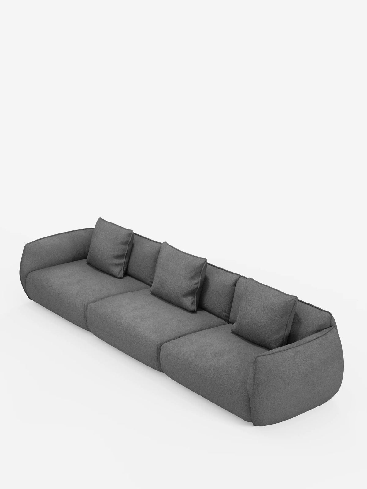 Un divano modulare Nimbus moderno e dal profilo basso, a 3 posti, realizzabile in morbido tessuto smacchiabile effetto cotone T33 di divitt.sbs, in grigio scuro con tre cuscini di seduta e tre cuscini dello schienale abbinati, caratterizzato da braccioli arrotondati e da un design minimalista, su uno sfondo bianco a tinta unita.
