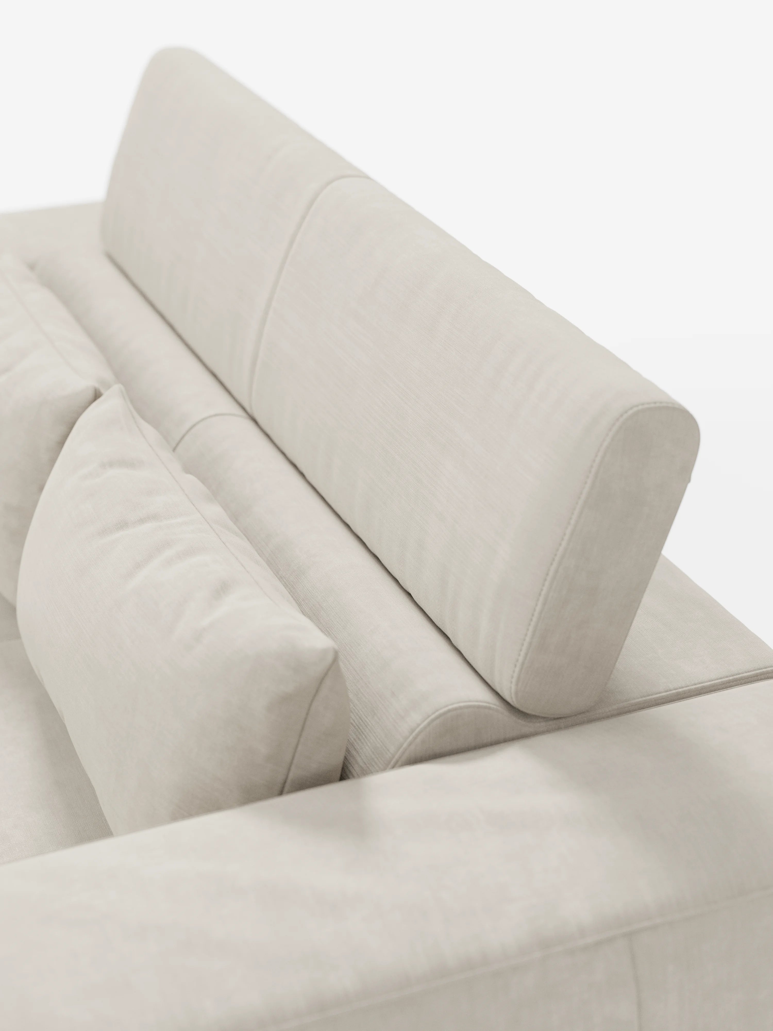 Primo piano del divano Monarch con relax elettrico di divitt.sbs, presentato in una moderna finitura beige chiaro con morbidi cuscini di seduta, schienale e braccioli. Questo divano è dotato di sedute allungabili, di un poggiatesta cilindrico reclinabile ed è rivestito in morbido tessuto T31 resistente alle macchie. Lo sfondo bianco a tinta unita mette in risalto le linee pulite e il colore neutro del modello Monarch.