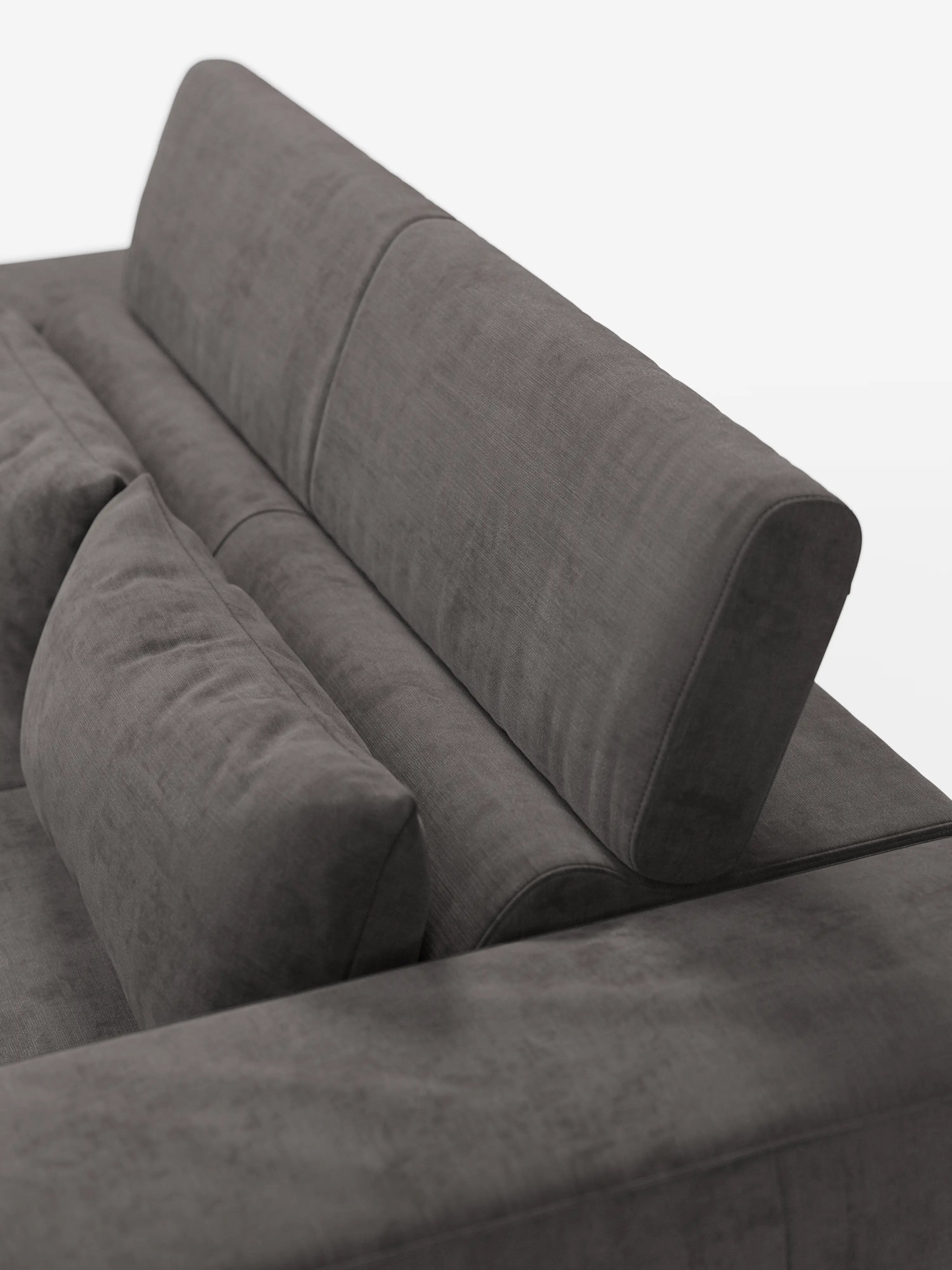Primo piano del divano Monarch con funzione relax elettrica di divitt.sbs, realizzato in morbido tessuto T31 grigio scuro resistente alle macchie, caratterizzato da cuscini soffici, schienale inclinato e un cuscino lombare aggiuntivo. Il rivestimento liscio e il design minimalista risaltano su uno sfondo bianco uniforme, con solo una parte del divano visibile.