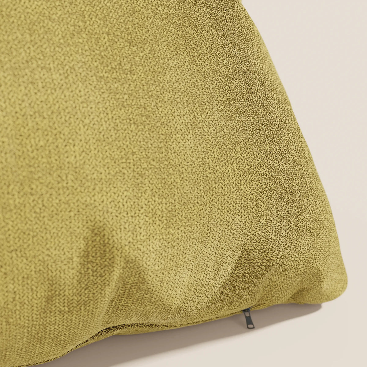 Primo piano del cuscino Destiny 45x45 cm di divitt.sbs in T02 giallo, realizzato in tessuto morbido e impermeabile con un sottile motivo maculato e un piccolo tiretto vicino al bordo inferiore, su uno sfondo beige chiaro.