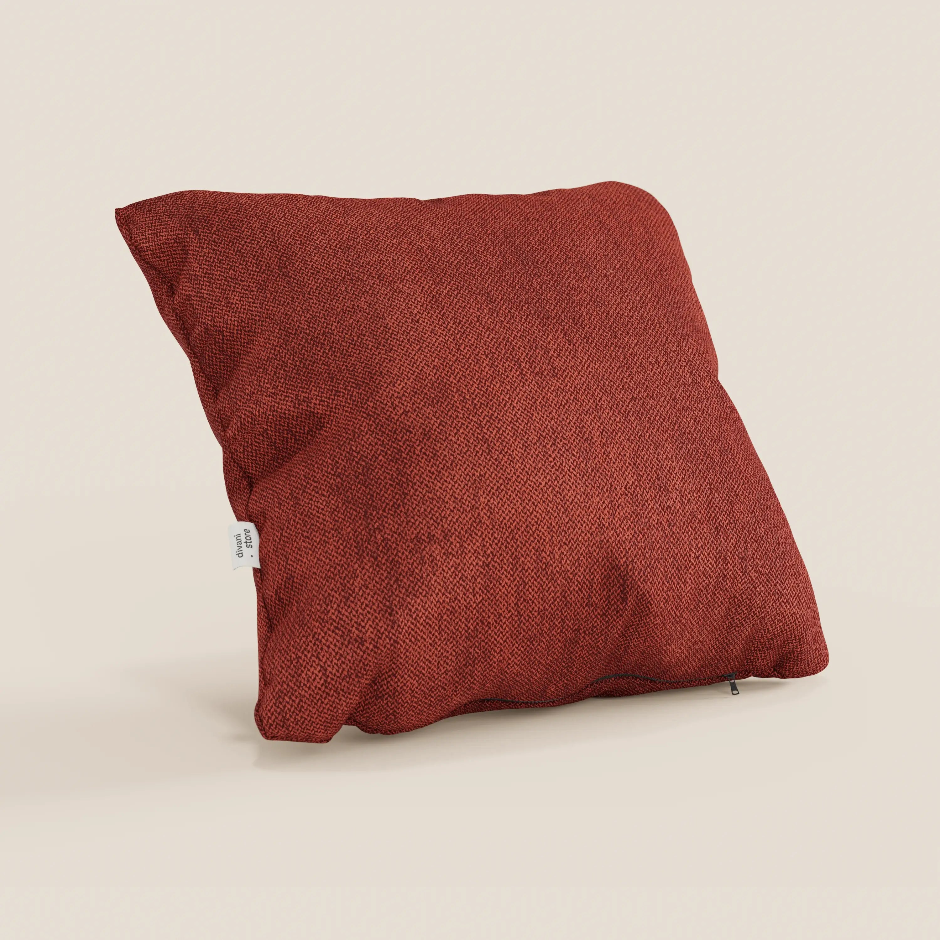 Un cuscino Sogno di divitt.sbs in tessuto morbido smacchiabile T05 rosso, di forma quadrata e di grandi dimensioni, con una piccola etichetta in tessuto bianco sulla sinistra, è appoggiato su uno sfondo color crema: morbido e perfetto come cuscino d'arredo per un comfort elegante.