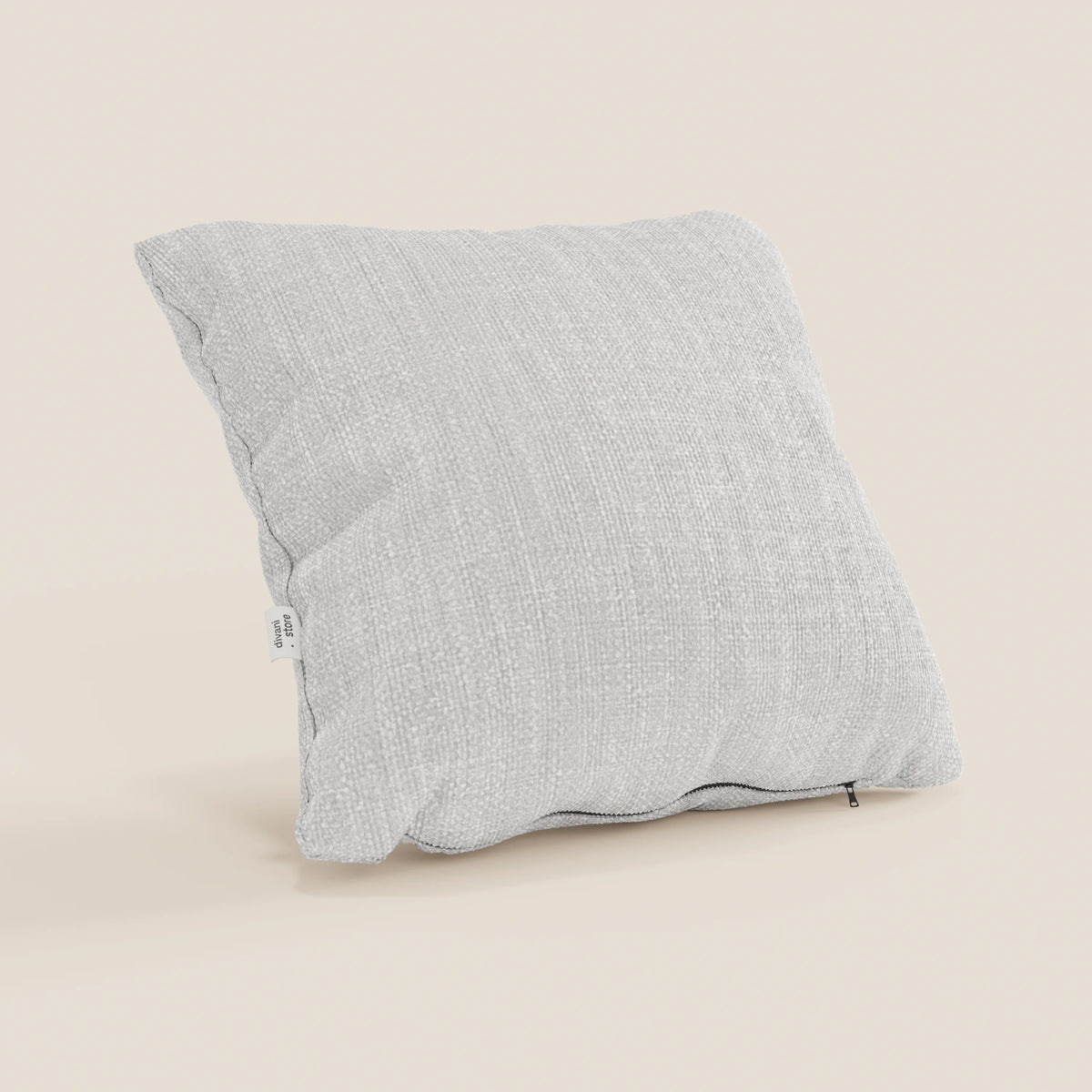 Il cuscino Lyon di divitt.sbs, nel formato 45x45 cm T06 grigio chiaro, è caratterizzato da un tessuto morbido intrecciato impermeabile, una targhetta bianca sulla cucitura sinistra e un tiretto in basso a destra su sfondo beige.