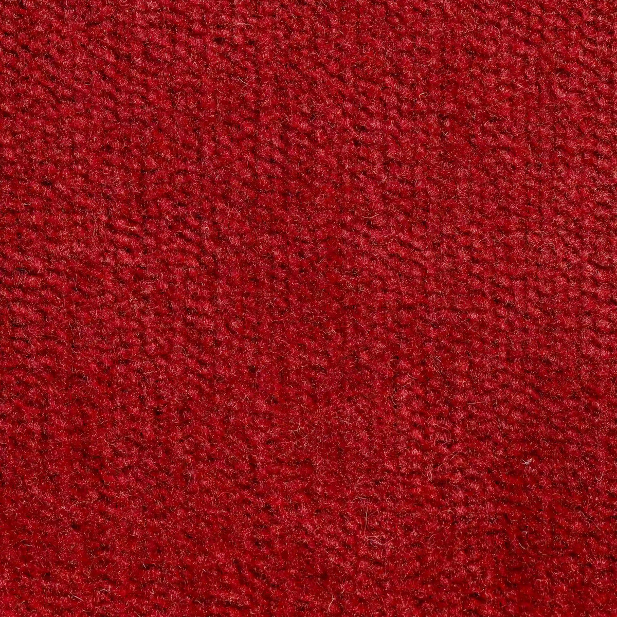 Primo piano del Bolero cuscino di divitt.sbs in rosso intenso: il tessuto T31, smacchiabile e impermeabile, è morbido al tatto e presenta una trama di piccole fibre in rilievo. Disponibile in vari colori e resistente al restringimento.