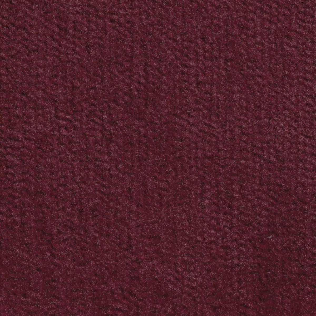 Primo piano del cuscino Bolero di divitt.sbs, in tessuto T31 bordeaux intenso, morbido, antimacchia, impermeabile e non restringente. Il suo sottile motivo intrecciato aggiunge calore e stile; disponibile in vari colori.