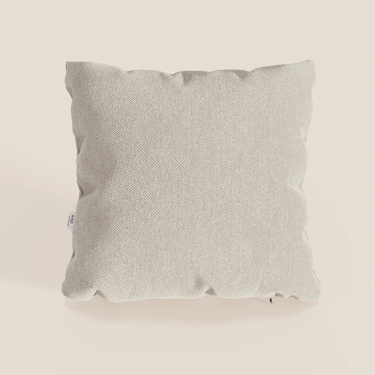 Il cuscino Sogno di divitt.sbs in panna SMACCHIABILE T05 è caratterizzato da un tessuto morbido, beige chiaro, con bordi leggermente frastagliati e una piccola etichetta bianca, ideale per aggiungere un comfort minimo al vostro divano.