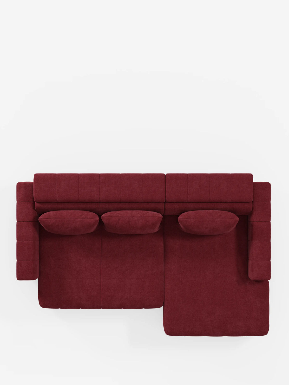 Vista dall'alto del divano angolare dorico con penisola e sedute allungabili con relax elettrico di divitt.sbs, rivestito in tessuto T23 rosso intenso resistente alle macchie. Questo moderno divano componibile è dotato di tre cuscini di seduta, tre cuscini rettangolari abbinati e una chaise longue (penisola) orientata verso destra, con poggiatesta regolabili per un maggiore comfort. Il divano è esposto su uno sfondo bianco.