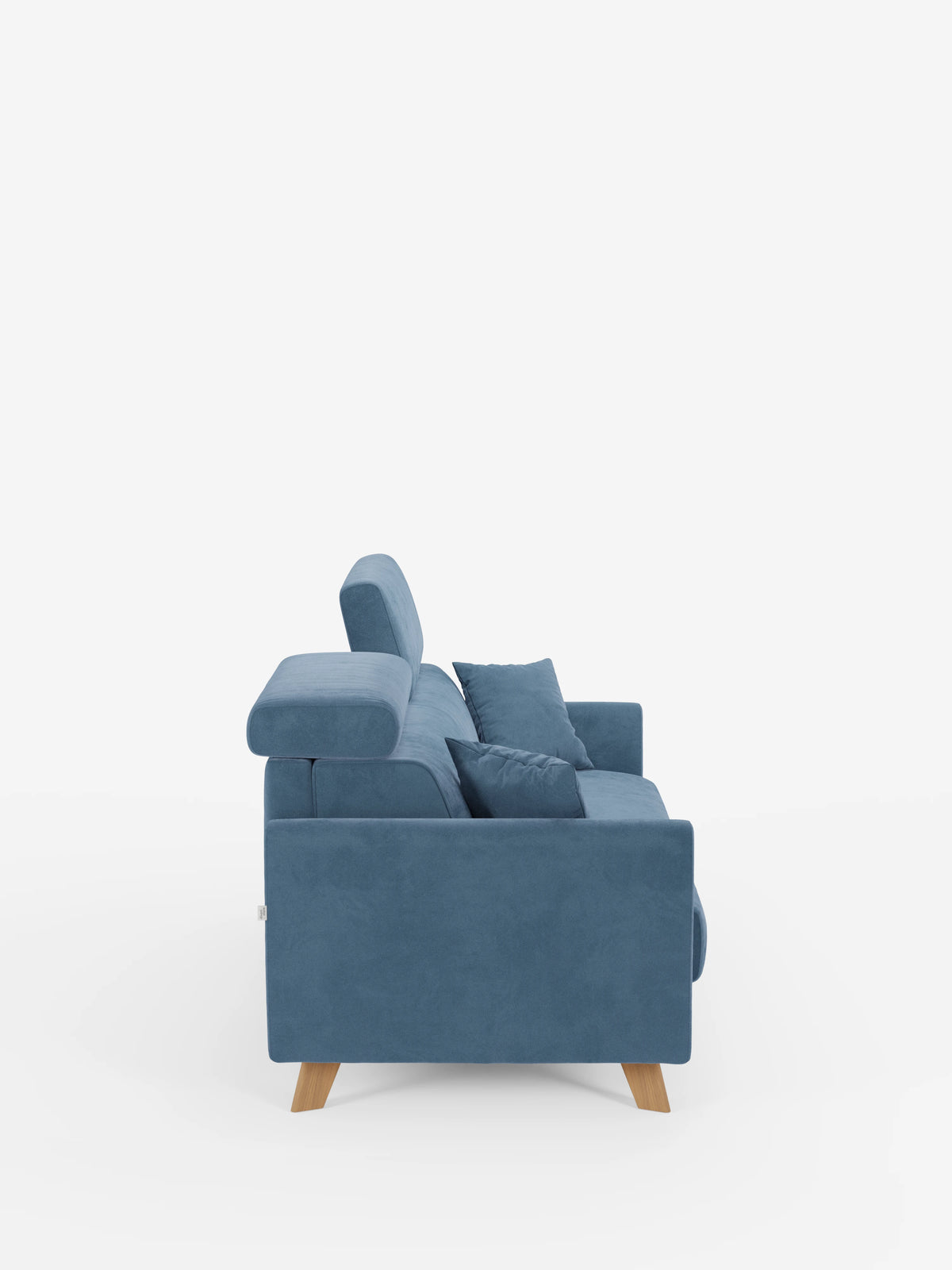 Vista laterale del divano letto Francy con poggiatesta regolabili di divitt.sbs, un moderno divano a tre posti realizzato in elegante tessuto blu T30 resistente alle macchie, caratterizzato da gambe in legno, poggiatesta regolabili e due cuscini coordinati. Il rivestimento, sfoderabile al 100%, e il design slanciato dalle linee dritte e pulite risaltano sullo sfondo bianco a tinta unita.