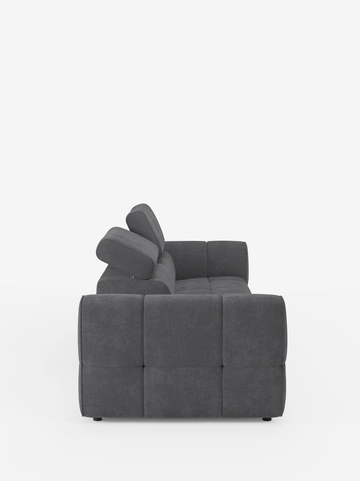 Un moderno divano componibile Giotto Divano in grigio scuro con terminale aperto – opzione relax elettrico in tessuto smacchiabile T23, visto di profilo con seduta capitonné, ampi braccioli e due poggiatesta regolabili su sfondo bianco.