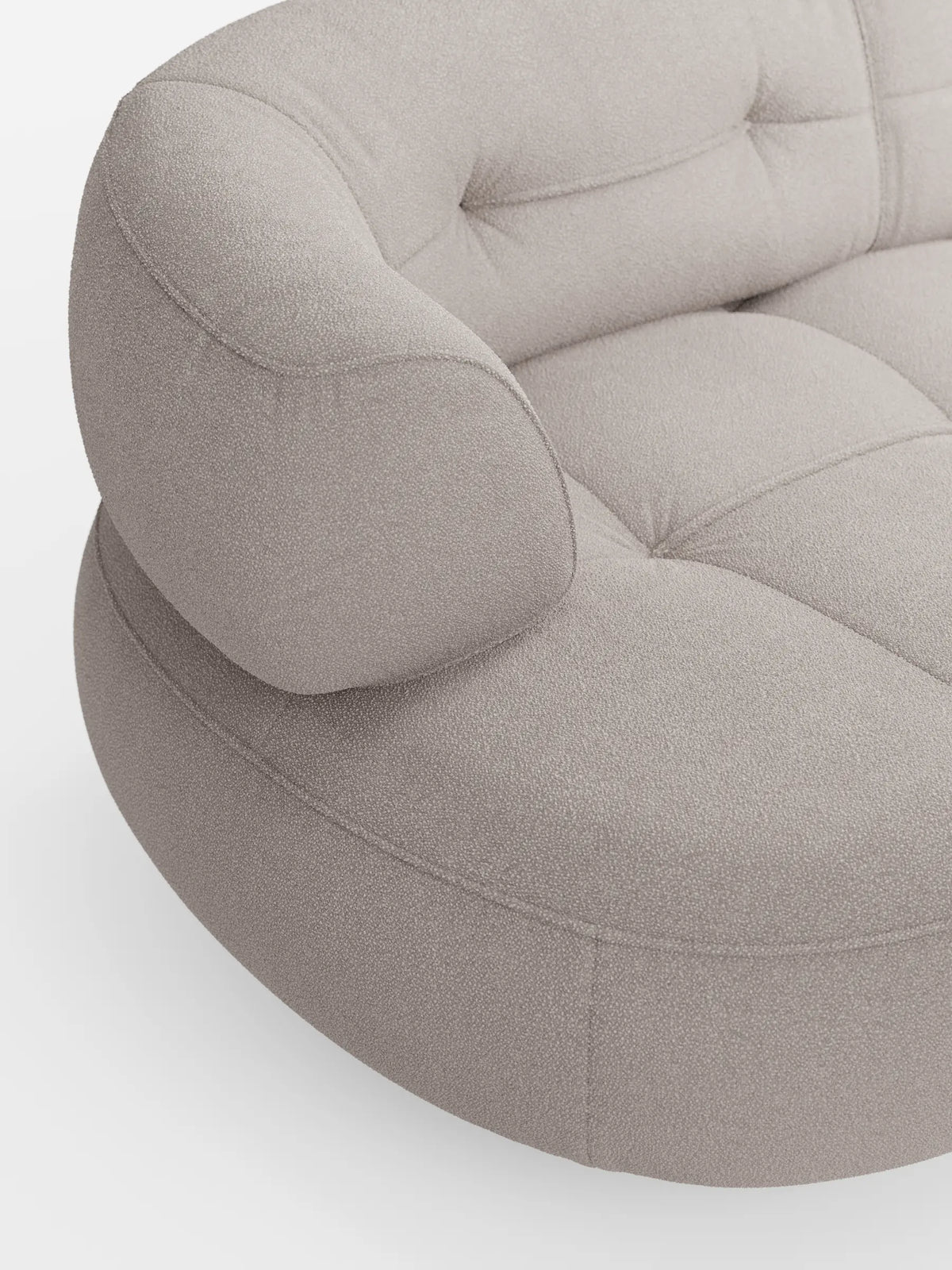 Un divano angolare Croissant dalla forma ricurva a fagiolo, con schienali scorrevoli in morbido tessuto effetto cotone smacchiabile T33 color beige chiaro, caratterizzato da dettagli trapuntati sulla seduta e da uno schienale arrotondato su sfondo bianco.