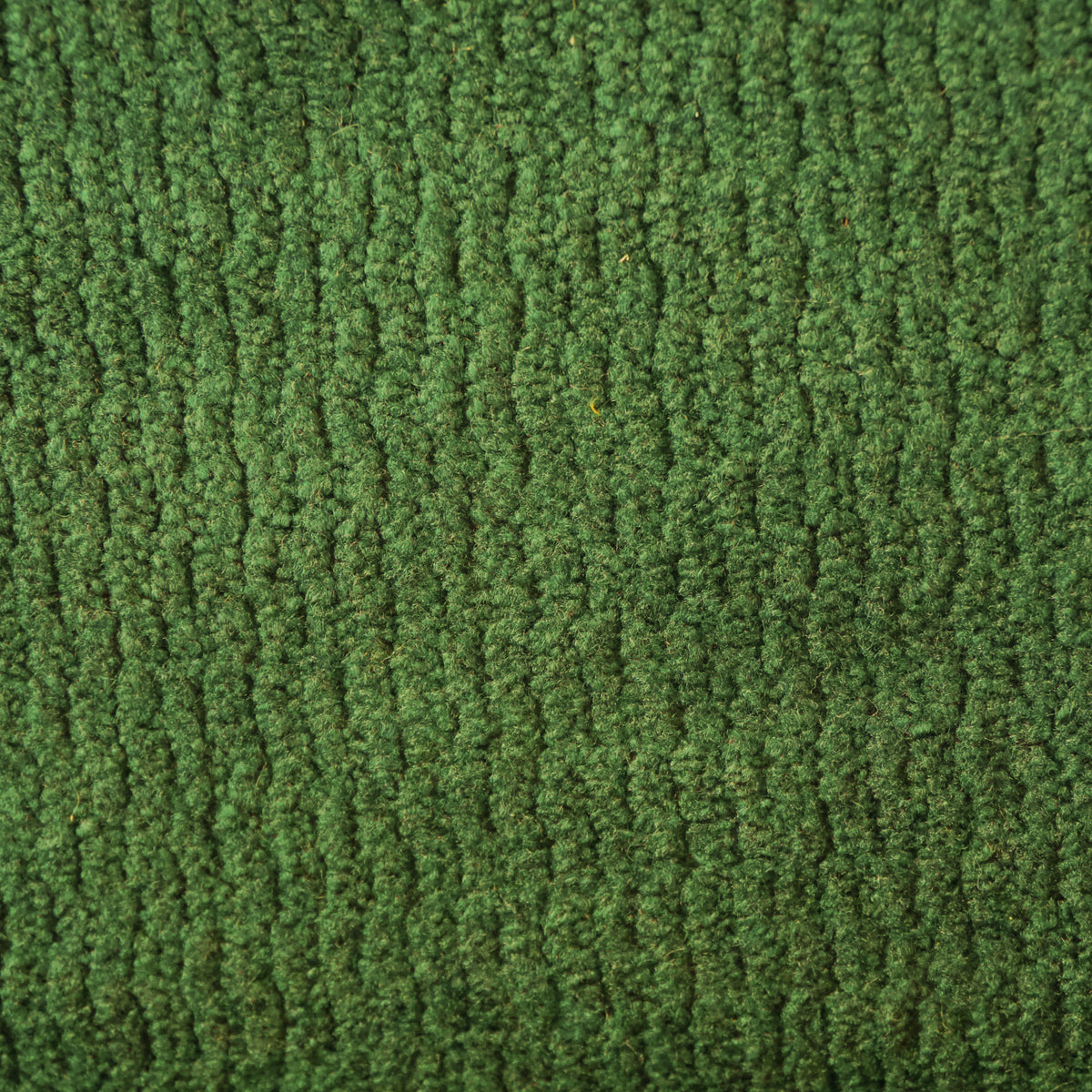 Un primo piano del tessuto “Personalizzazione” in T32 KENDAL color verde bosco, caratterizzato da una trama spessa e ruvida con nervature verticali in rilievo che ricordano il velluto a coste.